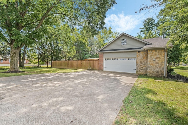 exterior space featuring a garage and a front yard