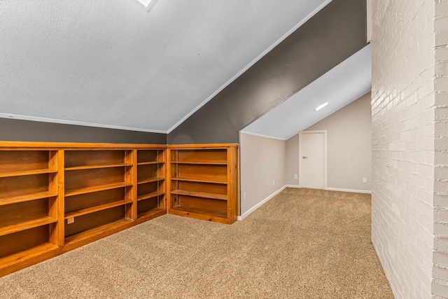 bonus room with vaulted ceiling, light colored carpet, and a textured ceiling