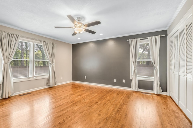 unfurnished bedroom with crown molding, ceiling fan, and light hardwood / wood-style floors