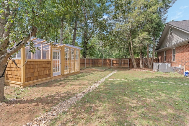 view of yard featuring an outbuilding and central AC unit