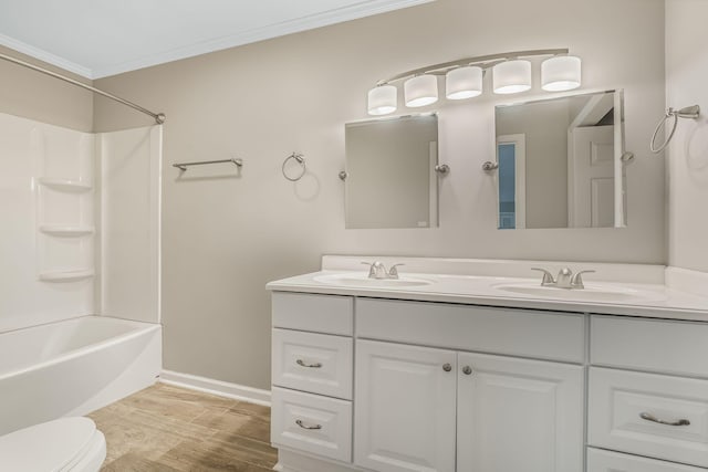 full bathroom with shower / bathing tub combination, hardwood / wood-style flooring, vanity, toilet, and crown molding