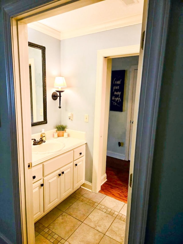 bathroom with vanity, crown molding, and tile patterned floors