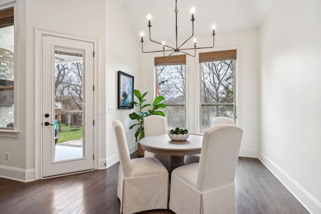 dining room featuring an inviting chandelier and dark hardwood / wood-style floors