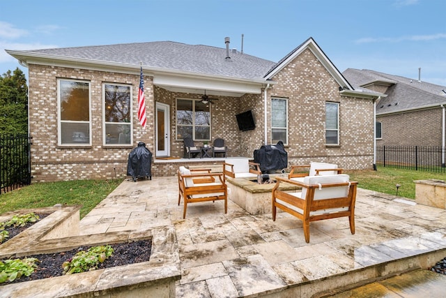 back of property featuring an outdoor living space with a fire pit, ceiling fan, and a patio area