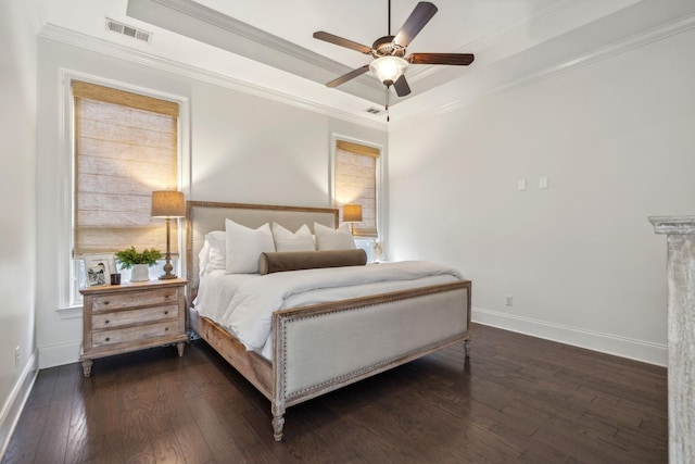 bedroom featuring crown molding, ceiling fan, dark hardwood / wood-style floors, and a raised ceiling