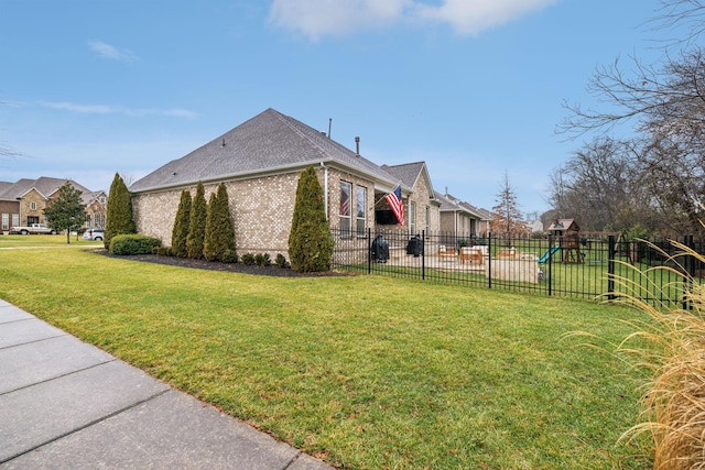 view of side of home with a lawn