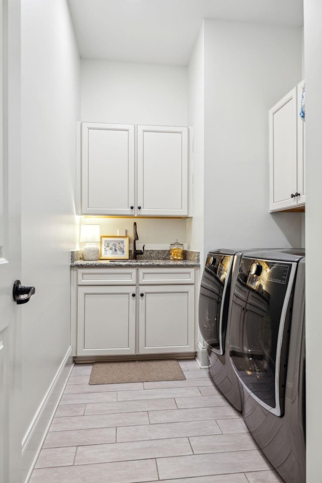 laundry area with cabinets and separate washer and dryer