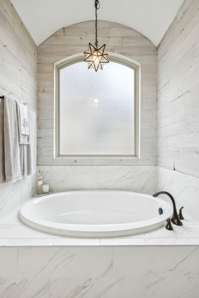 bathroom featuring tiled tub