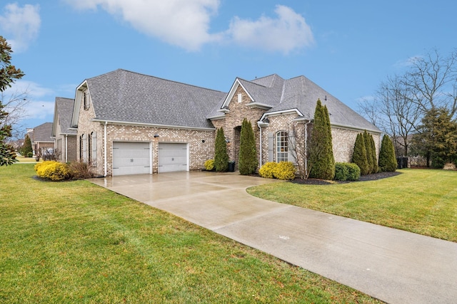 view of front of home with a garage and a front lawn