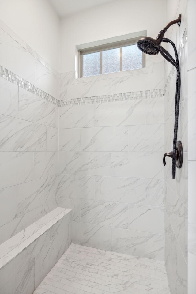 bathroom with tiled shower