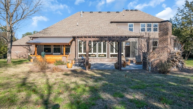 rear view of house with a pergola, a lawn, and a patio