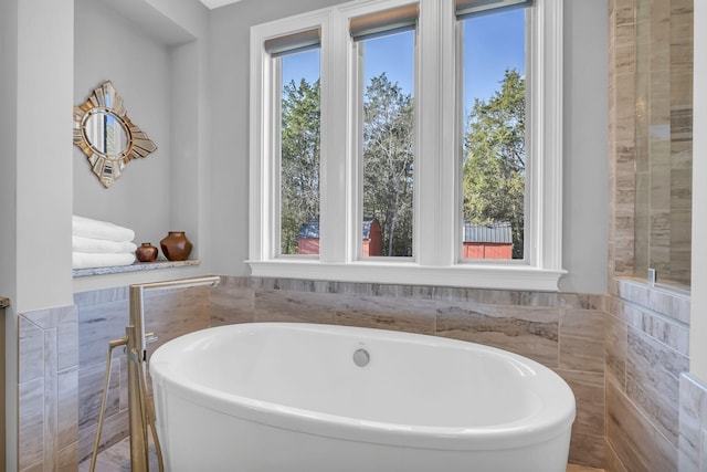 bathroom featuring a bathing tub and tile walls