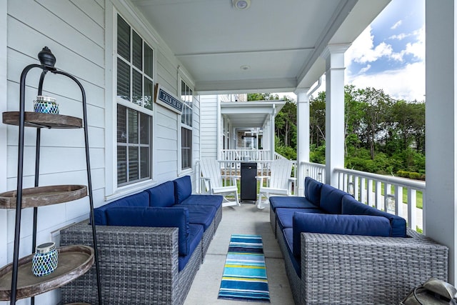 deck with an outdoor living space and covered porch