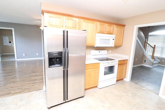 kitchen with light brown cabinets and white appliances