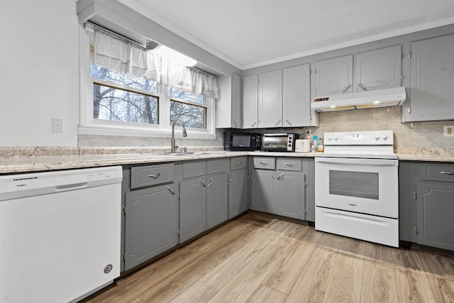 kitchen featuring white appliances, gray cabinets, and light hardwood / wood-style floors