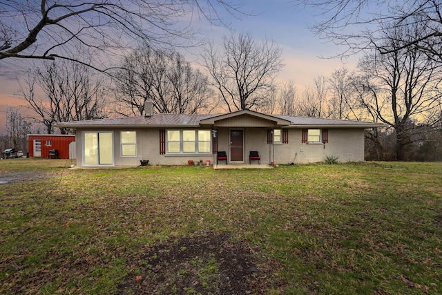 ranch-style home with a lawn