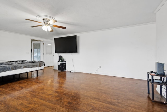 bedroom featuring dark hardwood / wood-style flooring, crown molding, and ceiling fan