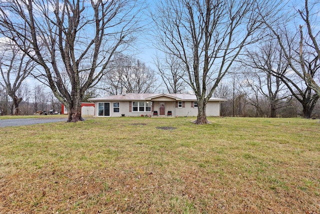 single story home featuring a front lawn