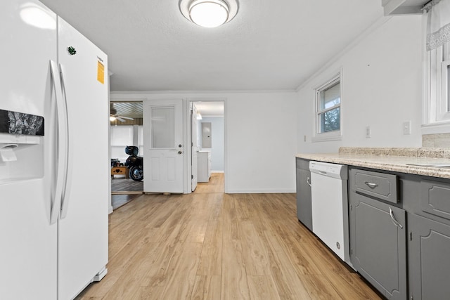 kitchen featuring white appliances, gray cabinets, light hardwood / wood-style floors, and a textured ceiling