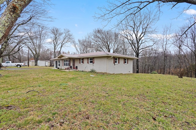 back of house with a lawn