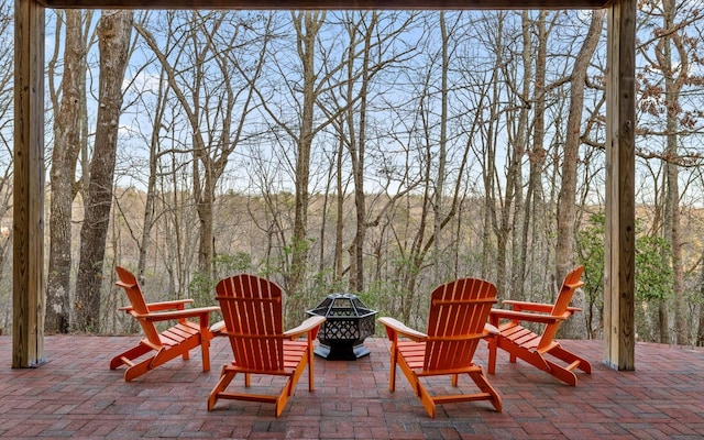 126 Stone Bridge Trl W, Dunlap, TN 37327 - view of patio featuring an outdoor fire pit and a wooded view