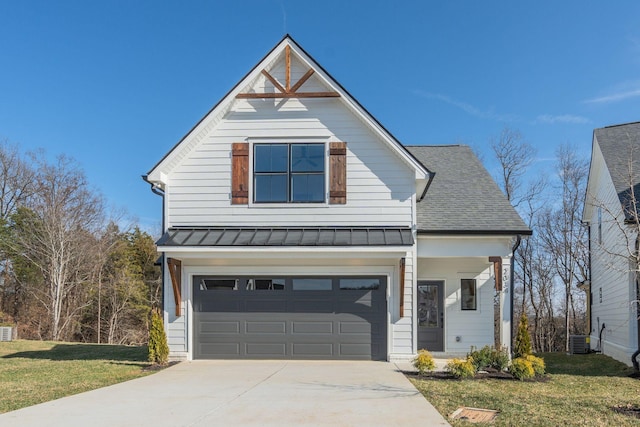 view of front facade featuring a garage, central AC unit, and a front yard