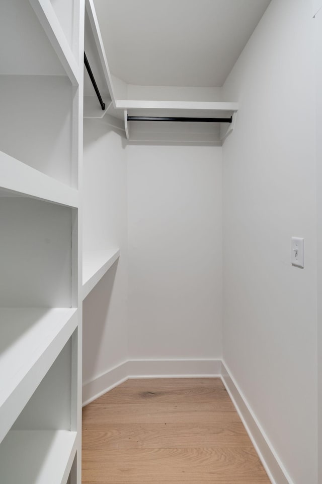 spacious closet with light hardwood / wood-style floors