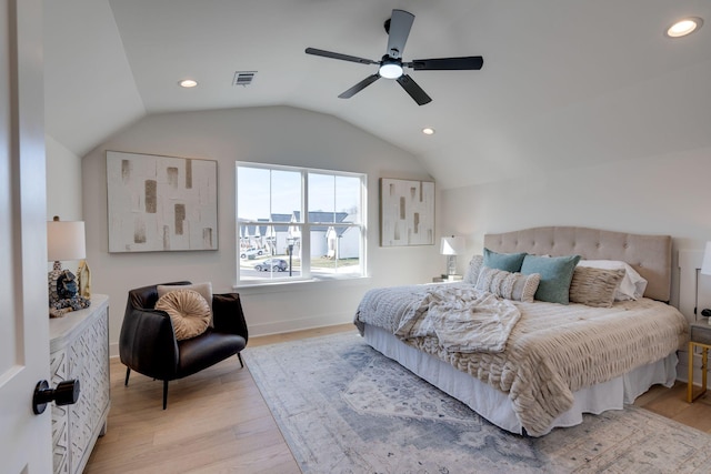 bedroom with vaulted ceiling, light hardwood / wood-style floors, and ceiling fan