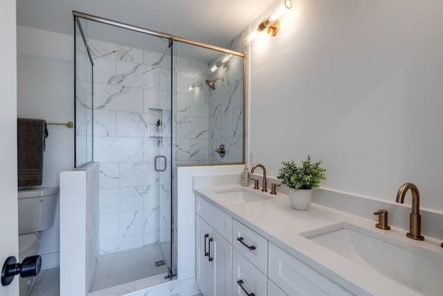 bathroom featuring vanity, toilet, and a shower with door