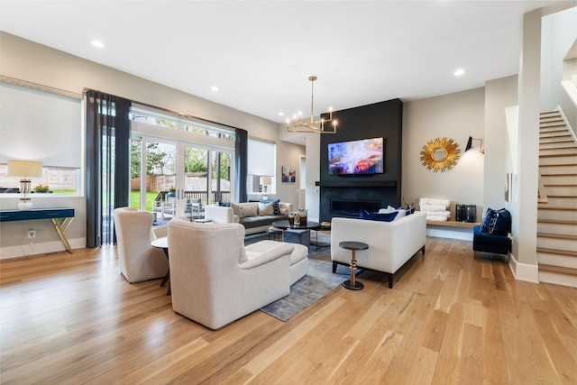 living room featuring an inviting chandelier and light hardwood / wood-style flooring