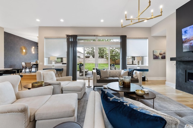 living room featuring light hardwood / wood-style floors and a chandelier