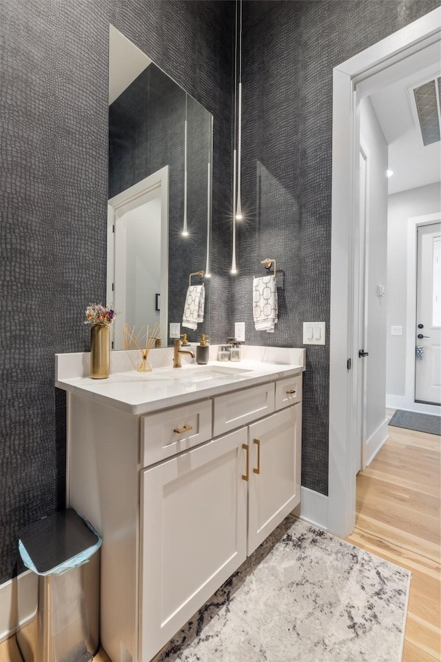 bathroom with vanity and wood-type flooring