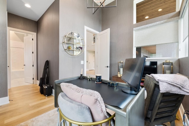 office featuring light hardwood / wood-style flooring and a high ceiling