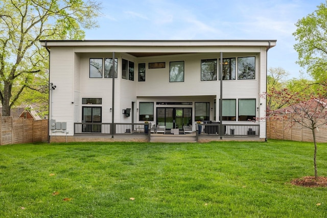 rear view of house featuring a lawn