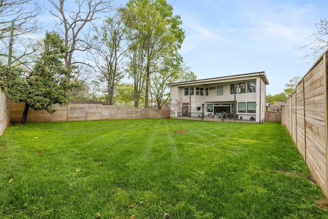 rear view of property with a lawn and a patio area