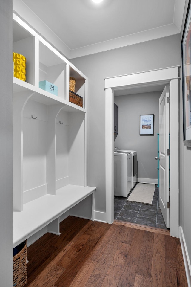 mudroom with dark hardwood / wood-style flooring, crown molding, and washer and clothes dryer