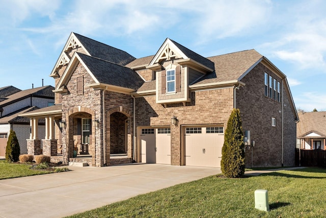 view of front of house featuring a garage, a porch, and a front yard