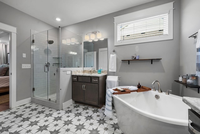 bathroom featuring vanity and independent shower and bath