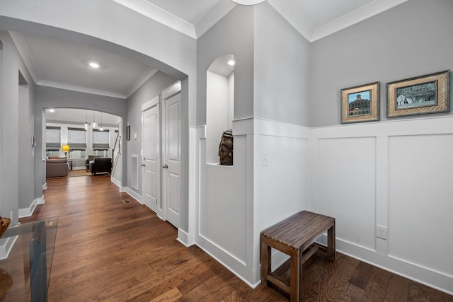 hallway featuring ornamental molding and dark hardwood / wood-style flooring