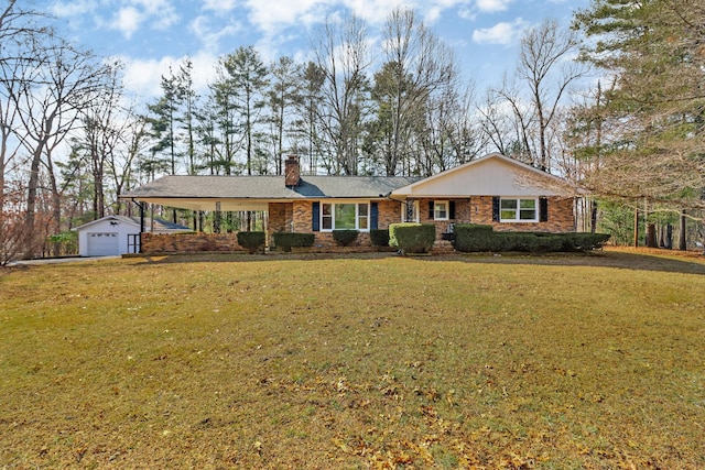 single story home featuring an outbuilding, a garage, and a front lawn