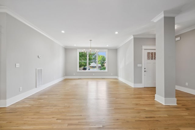 unfurnished living room with crown molding, light hardwood / wood-style flooring, and a notable chandelier