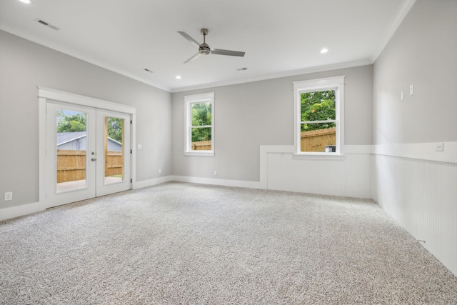 empty room with french doors, ceiling fan, ornamental molding, and carpet floors