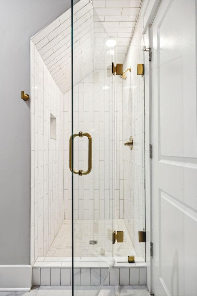 bathroom with a shower with door