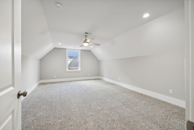 additional living space featuring vaulted ceiling, carpet, and ceiling fan