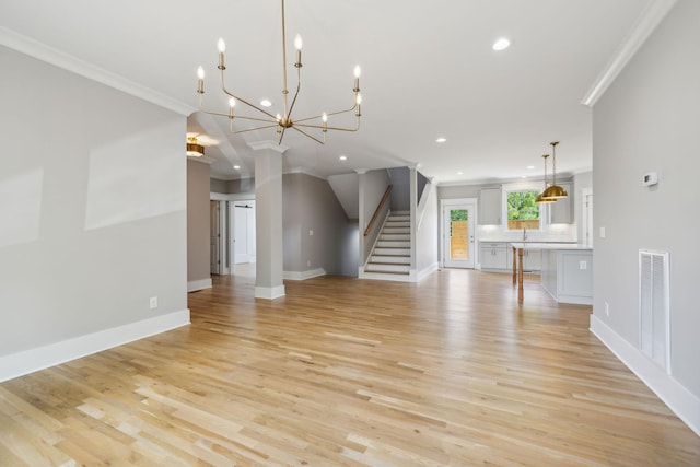 unfurnished living room featuring ornamental molding and light hardwood / wood-style flooring