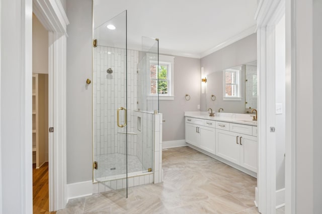 bathroom with vanity, ornamental molding, and a shower with door