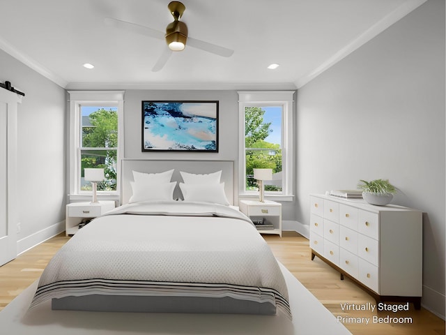 bedroom featuring multiple windows, crown molding, and light hardwood / wood-style flooring