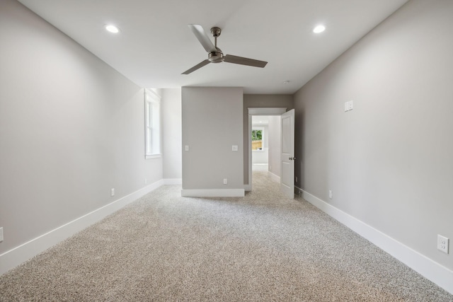 carpeted empty room featuring plenty of natural light and ceiling fan