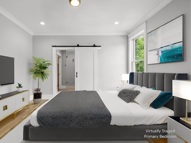 bedroom with light hardwood / wood-style flooring, ornamental molding, and a barn door