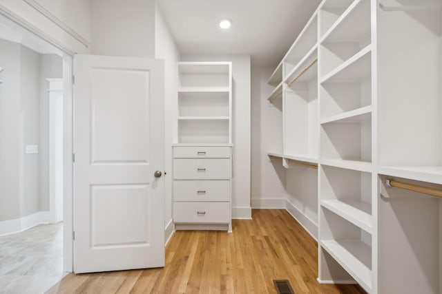 walk in closet featuring light hardwood / wood-style flooring